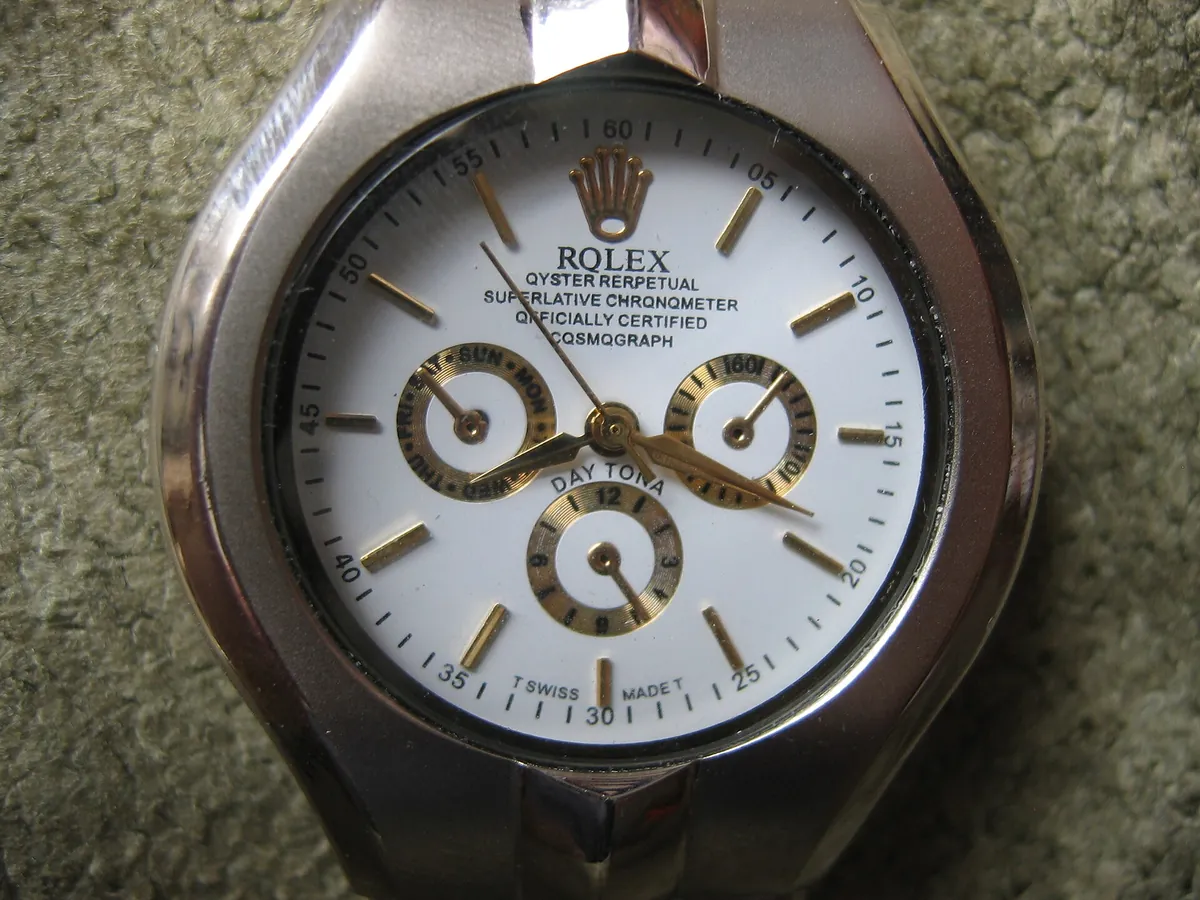 Counterfeit watch imitating a Rolex Daytona with misspelt dial text, identified as fake by its source